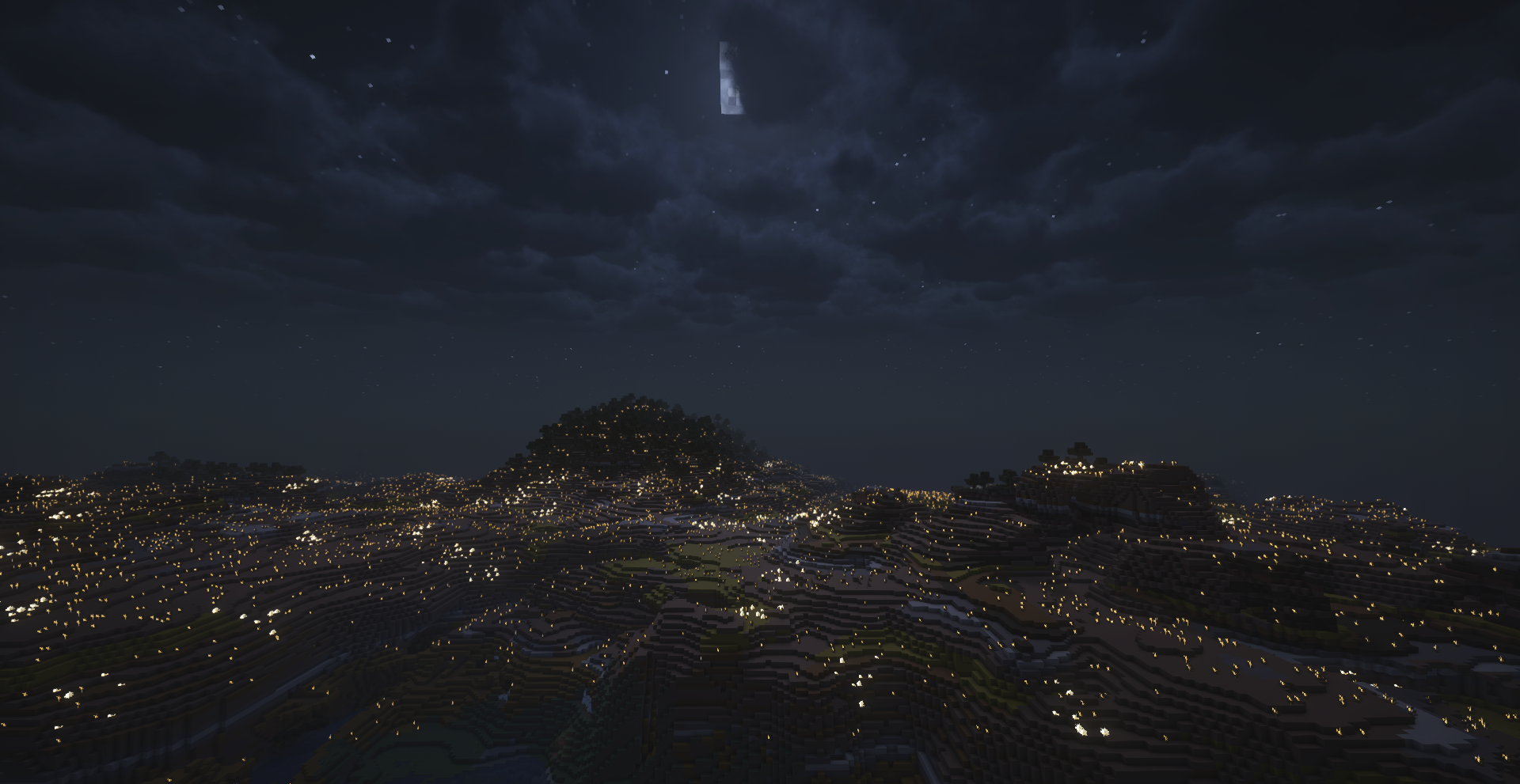 Paysage montagneux illuminé par des lumières nocturnes dans Minecraft avec Luminara Shader