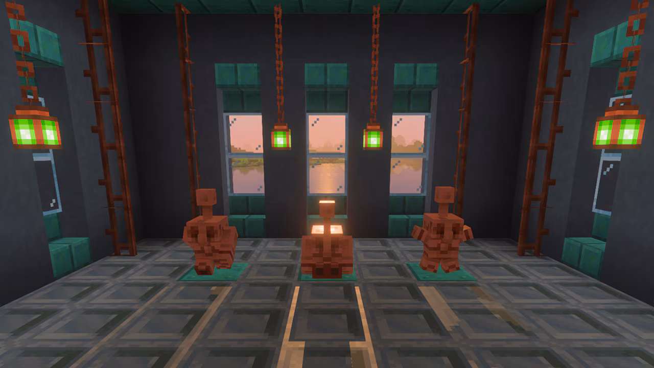 Trois statues de golem de cuivre sur des socles verts, lanternes suspendues et coucher de soleil.